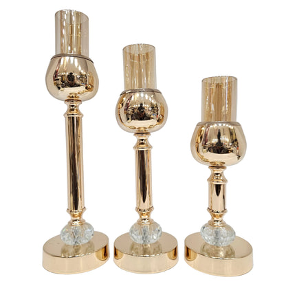 Gold-toned candle holders are featuring a polished finish and crystal accents