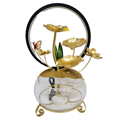 Tabletop water feature is a Lotus Bloom LED Fountain featuring golden metal lotus leaves and a butterfly decoration.