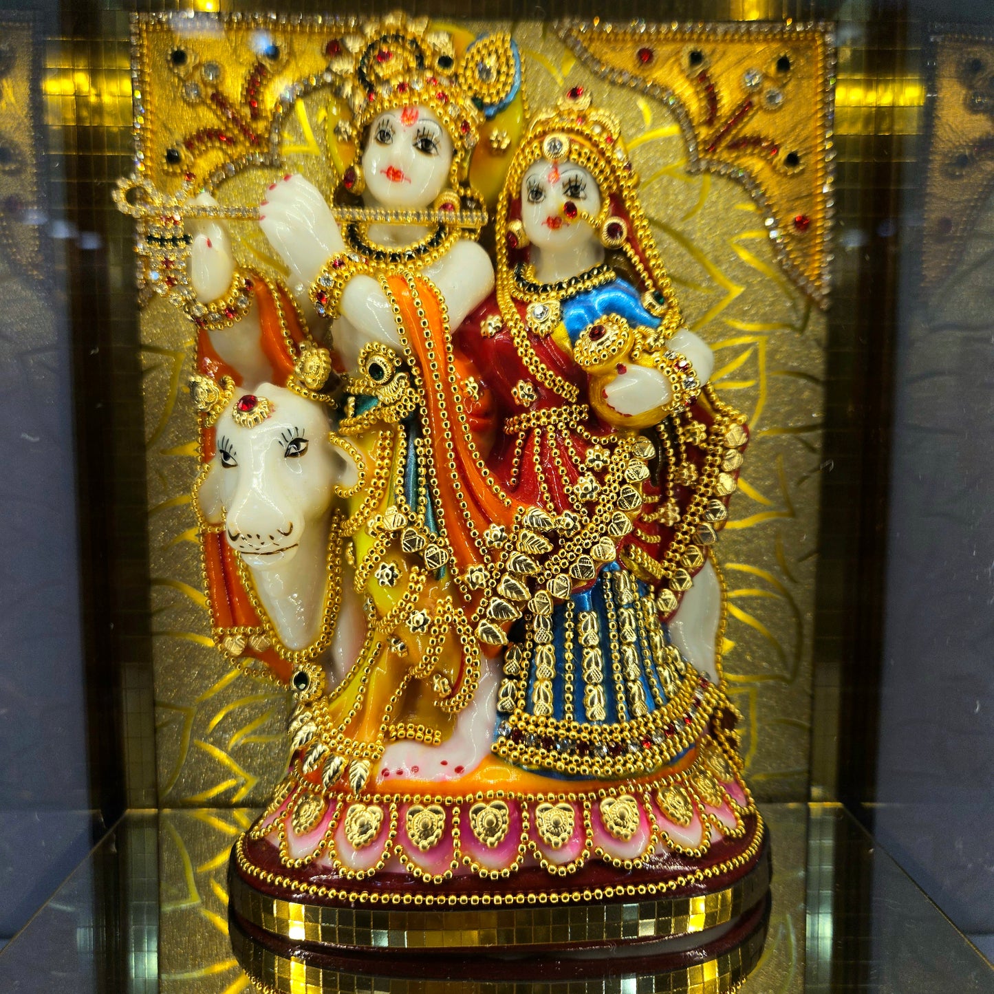 Radha Krishna attractive stones designed 24 carats gold Plated idol Statue showpiece in a transparent protective cabin
