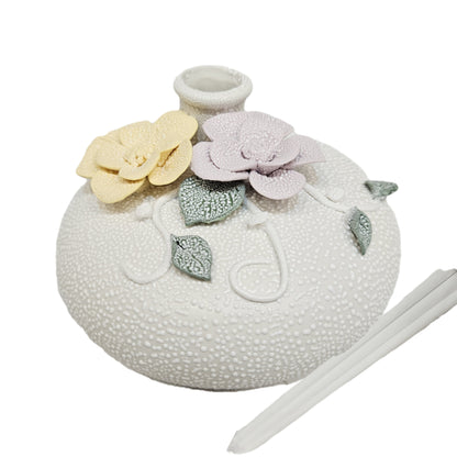 Handcrafted ceramic floral vase, an elegant decorative piece characterized by its unique texture and delicate relief work