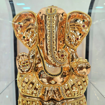 Lord Vinayaka murti 24carats gold Plated idol with attractive stones designed Statue in a transparent protective cabin
