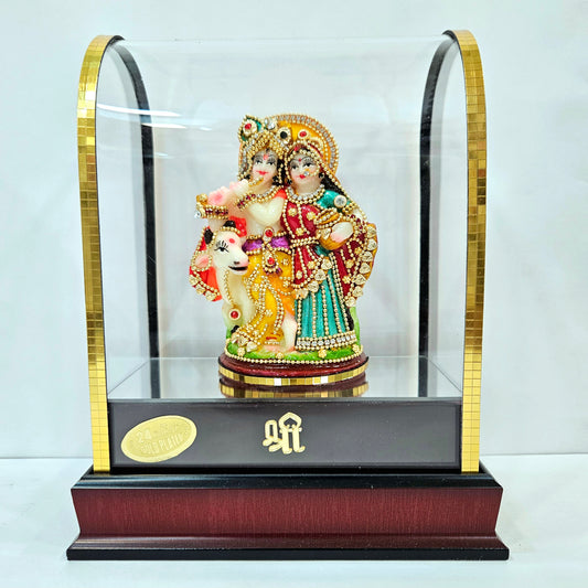 Radha Krishna 24carats gold Plated idol Decorated with attractive stones in a transparent protective cabin