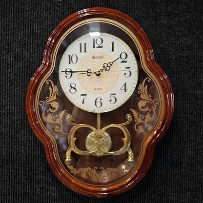 Decorative wall clock with wooden frame and gold accents on a dark background