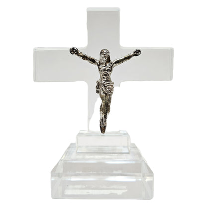 Standing crystal featuring a metal figure of Jesus Christ on a clear acrylic or glass cross. Items like this are popular as spiritual tabletop showpieces
