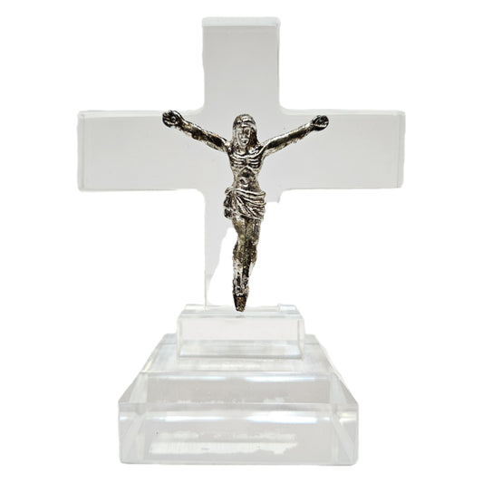 Standing crystal featuring a metal figure of Jesus Christ on a clear acrylic or glass cross. Items like this are popular as spiritual tabletop showpieces