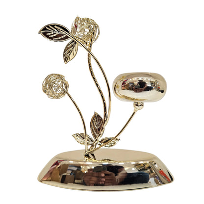 Golden metal tealight candle holder polished finish, intricate branch designs, and a single cup for holding candle