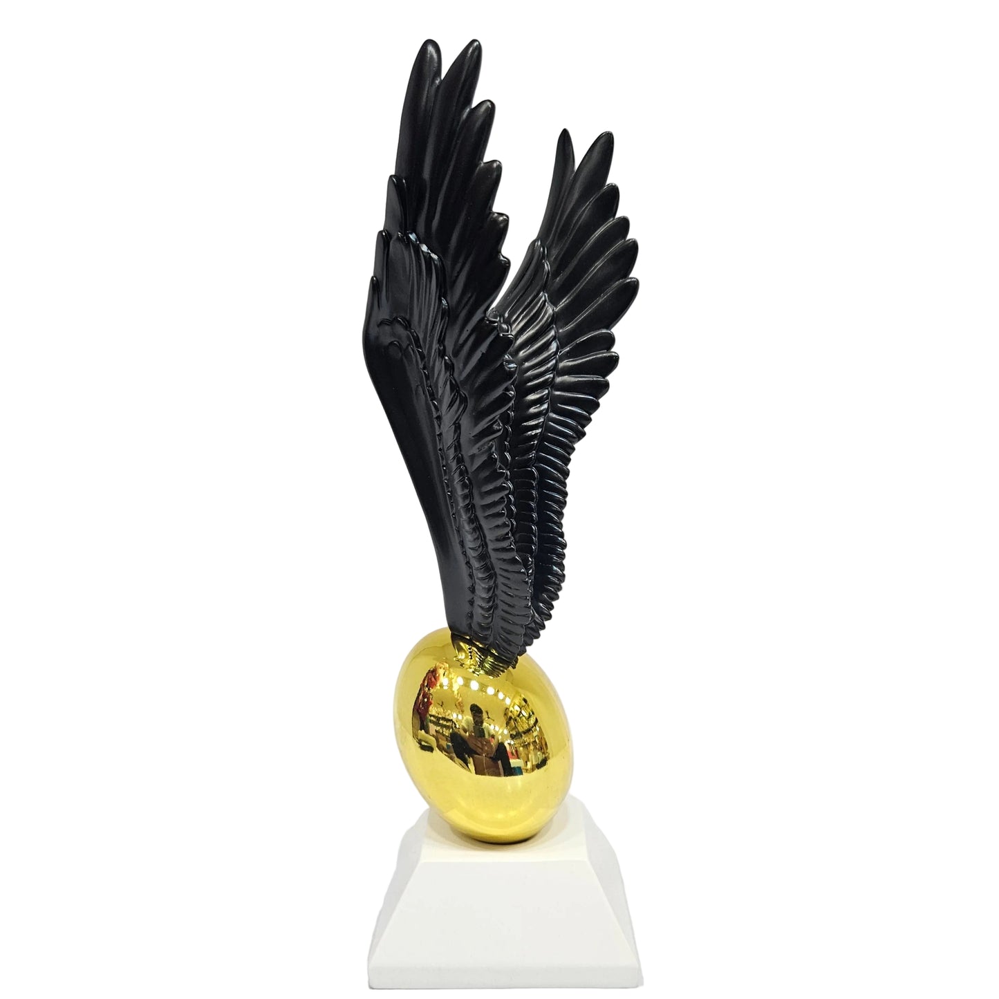 Decorative statue appears to be inspired by the Golden Snitch featuring a gold ball paired with black wings