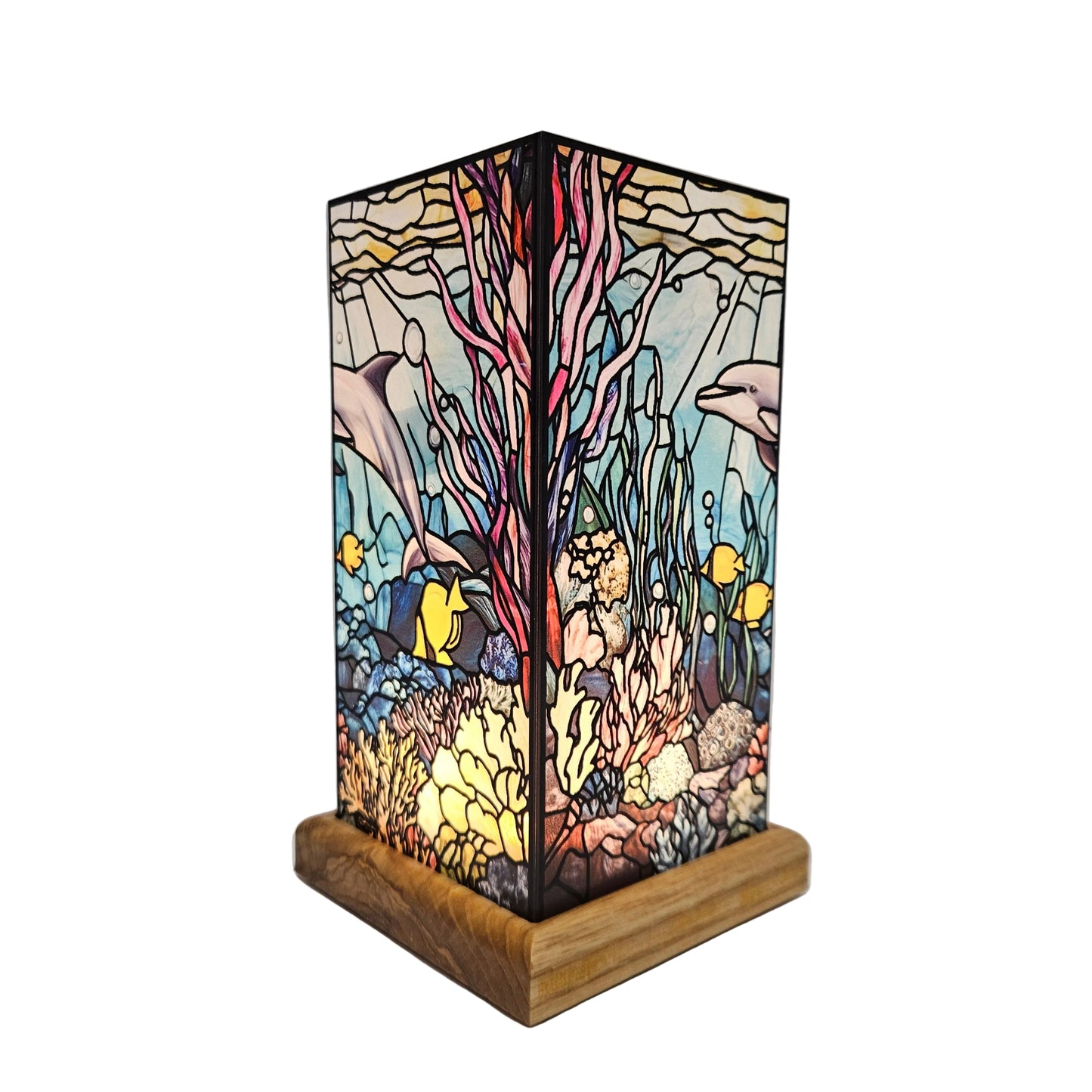 Tiffany-style stained glass dolphin table lamp features a vibrant coral reef scene atop a wooden base