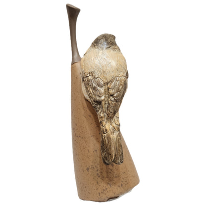 Decorative bird showpiece perched on an abstract pear, commonly crafted from textured polyresin for home decor