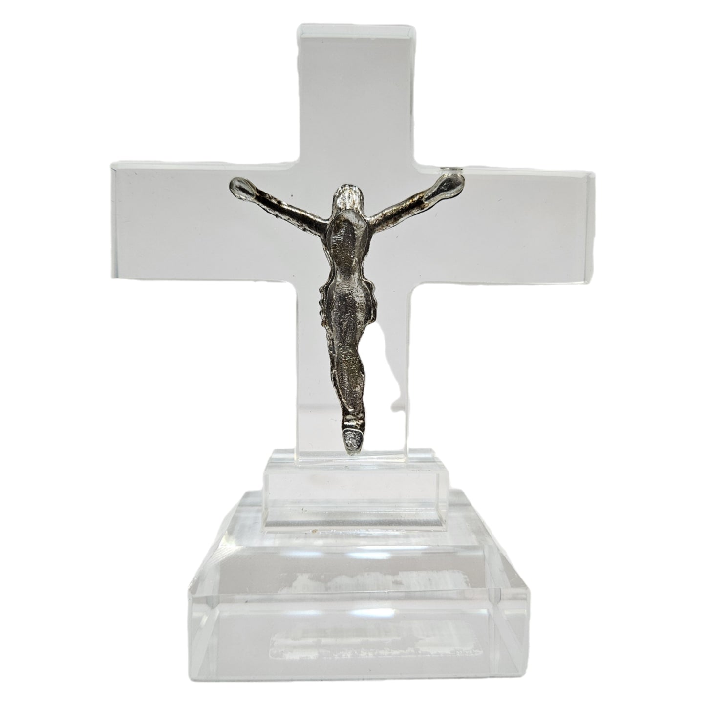Standing crystal featuring a metal figure of Jesus Christ on a clear acrylic or glass cross. Items like this are popular as spiritual tabletop showpieces