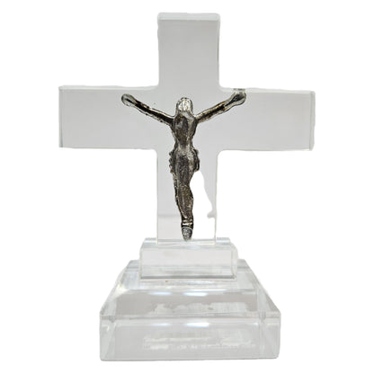 Standing crystal featuring a metal figure of Jesus Christ on a clear acrylic or glass cross. Items like this are popular as spiritual tabletop showpieces