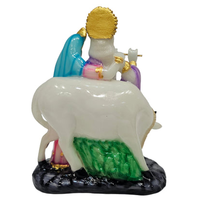 Polyresin Radha Krishna murti with cow intricate hand-painted details and a golden finish for home decor