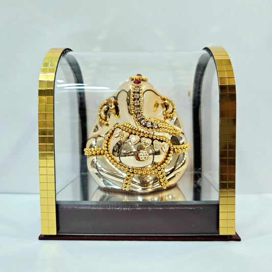 Lord vinayaka murti in a attractive look Decorated with stones designed in a transparent protective cabin