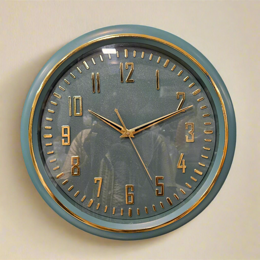 Round wall clock with gold accents on a dark textured background