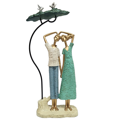 Graceful dancing couple figurine is crafted from resin and features a textured green and white finish Showpiece