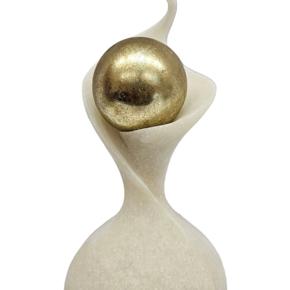 This abstract polyresin showpiece features a white sanded finish and a gold sphere
