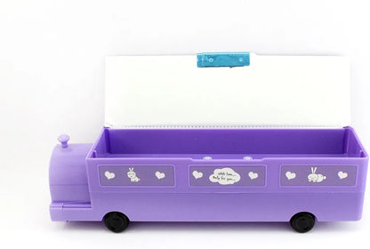 Purple pencil box shaped like a train or bus, designed for children. Additional detaIt has wheels, possibly for play.
The box features cartoon-like graphics with the word "SAUCE" visible.
It includes compartments and may have a built-in sharpener.