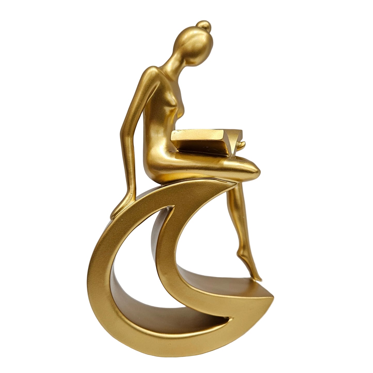 Gold-finished resin statue depicts a stylized figure reading a book while perched upon a crescent moon.