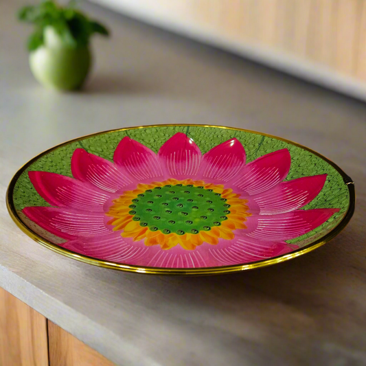 Decorative plate with a pink flower design on a black background