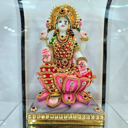 Lakshmi mata 24carats gold Plated idol Decorated with attractive stones in a transparent protective cabin