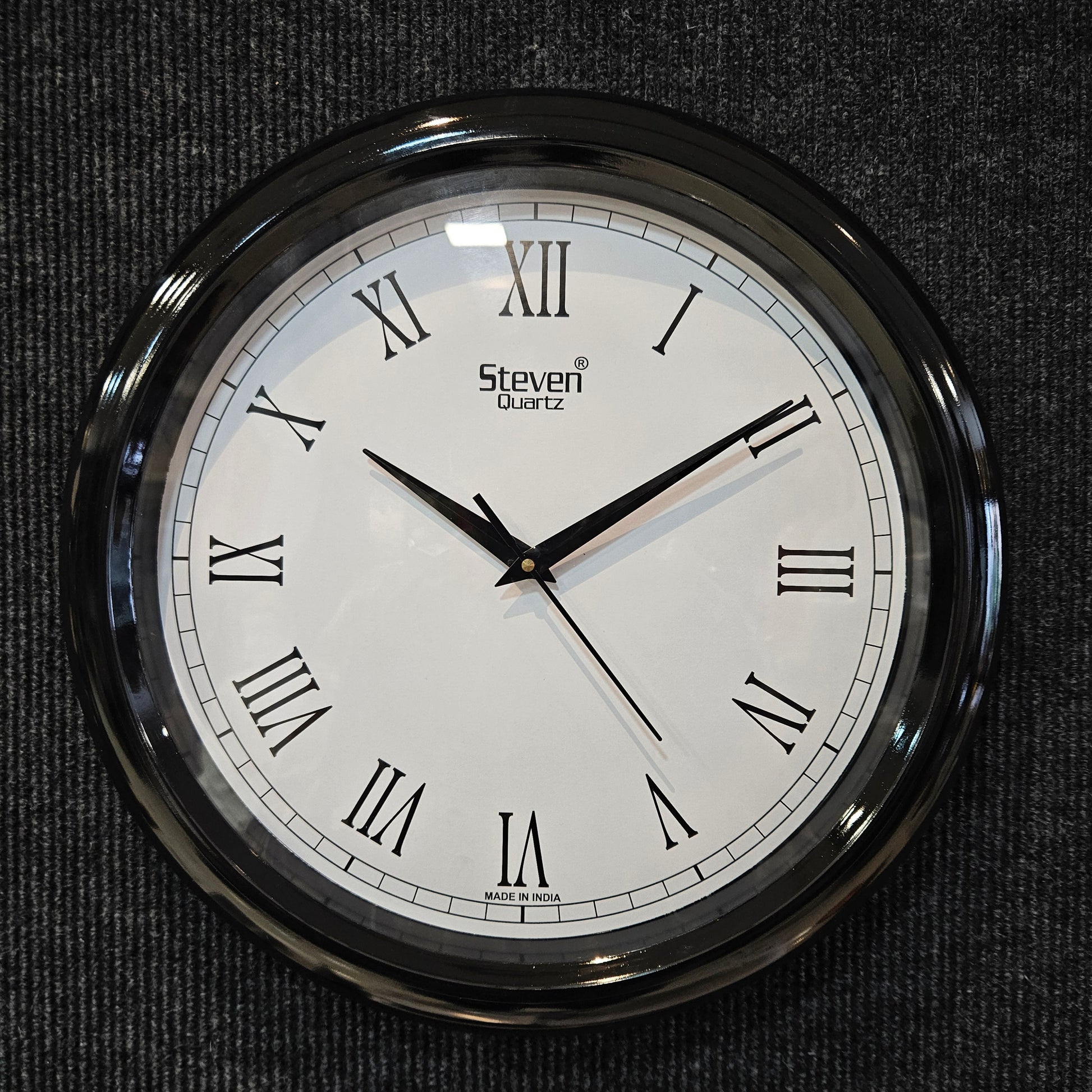 Round wall clock with Roman numerals on a dark textured background
