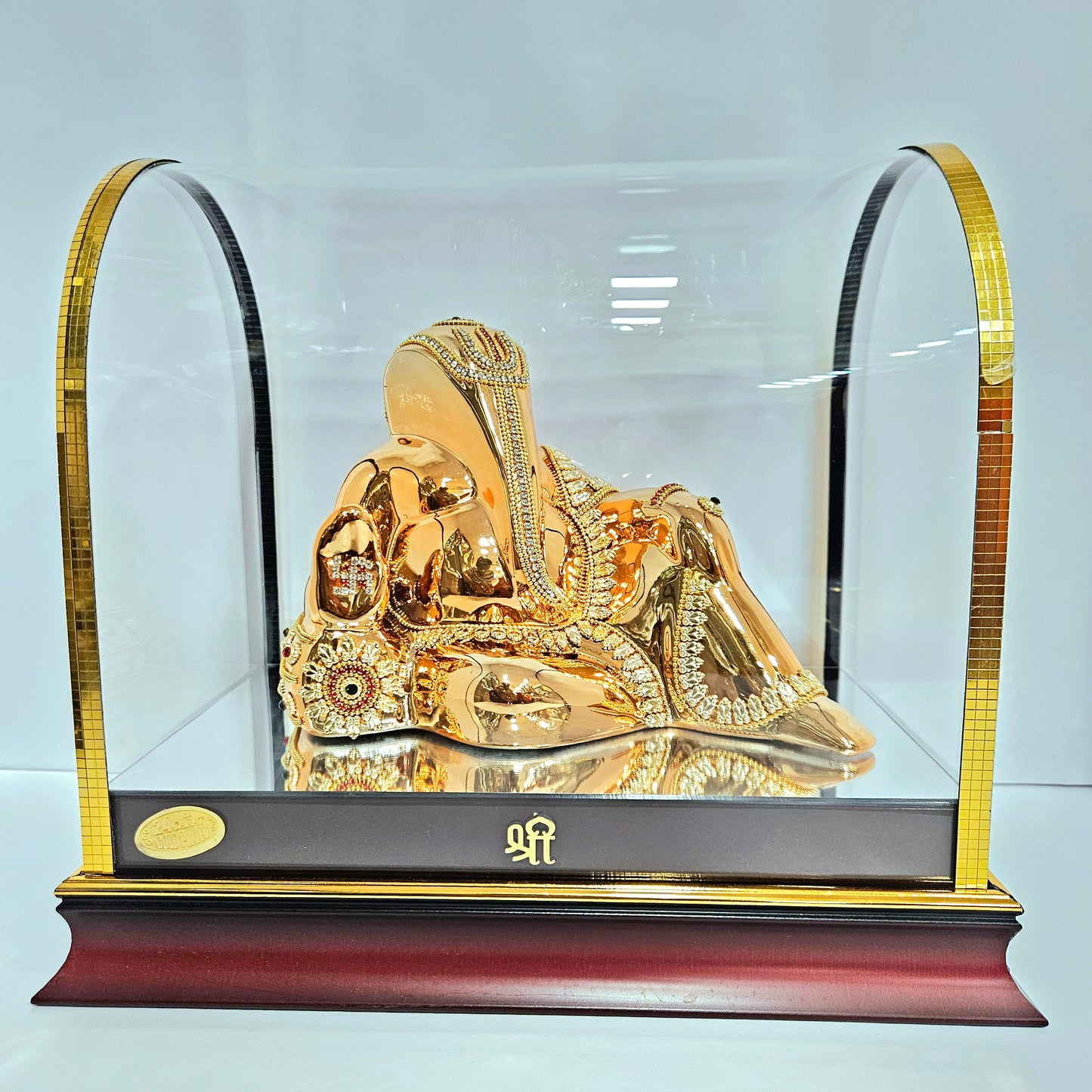 Decorative Ganesh ji Statue idol in resting position with stones design in transparent protective cabin