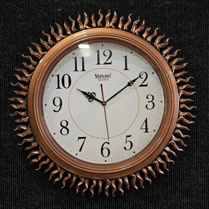 Decorative wall clock with sunburst design on a black background