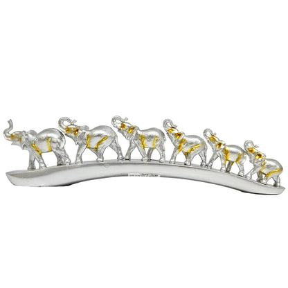 Decorative showpiece featuring six elephants walking in a row along a curved, bridge-like base