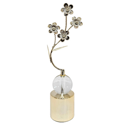 Elegant metal floral table showpiece featuring a crystal ball accent on a golden cylindrical pedestal base