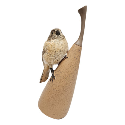 Decorative bird showpiece perched on an abstract pear, commonly crafted from textured polyresin for home decor