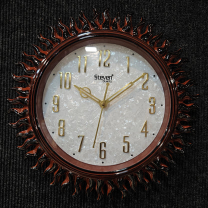 Decorative wall clock with sunburst design on a black background