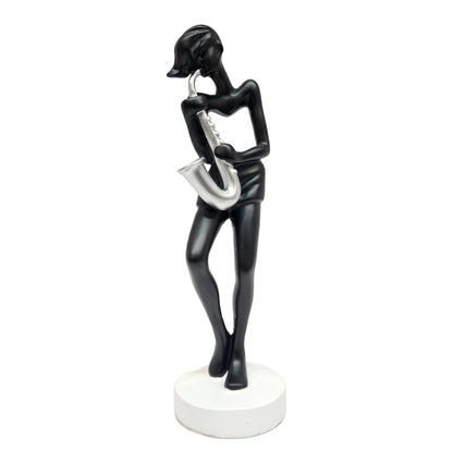 polyresin statue depicts a saxophone player in a black and silver finish, standing approximately tall on a white base