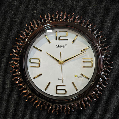 Decorative wall clock with gold Roman numerals on a black background