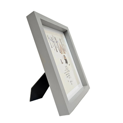 Decorative wall art print in a gray frame featuring a whimsical bear character photo frame