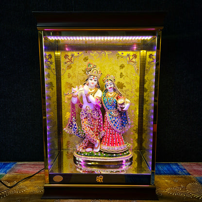 24 carats gold Plated radha Krishna Idol Statue Decorated with attractive stones in a transparent protective cabin with lights