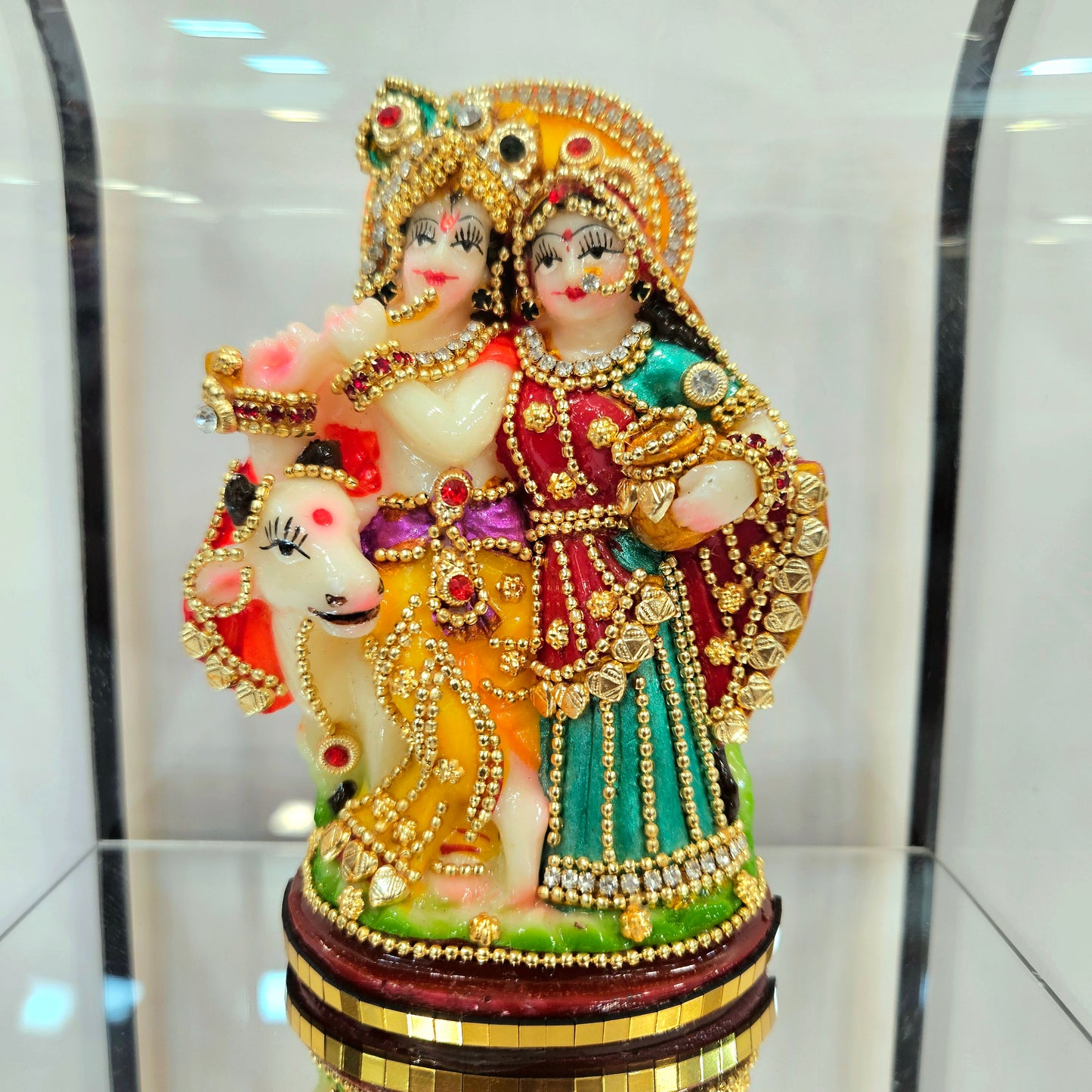 Radha Krishna 24carats gold Plated idol Decorated with attractive stones in a transparent protective cabin