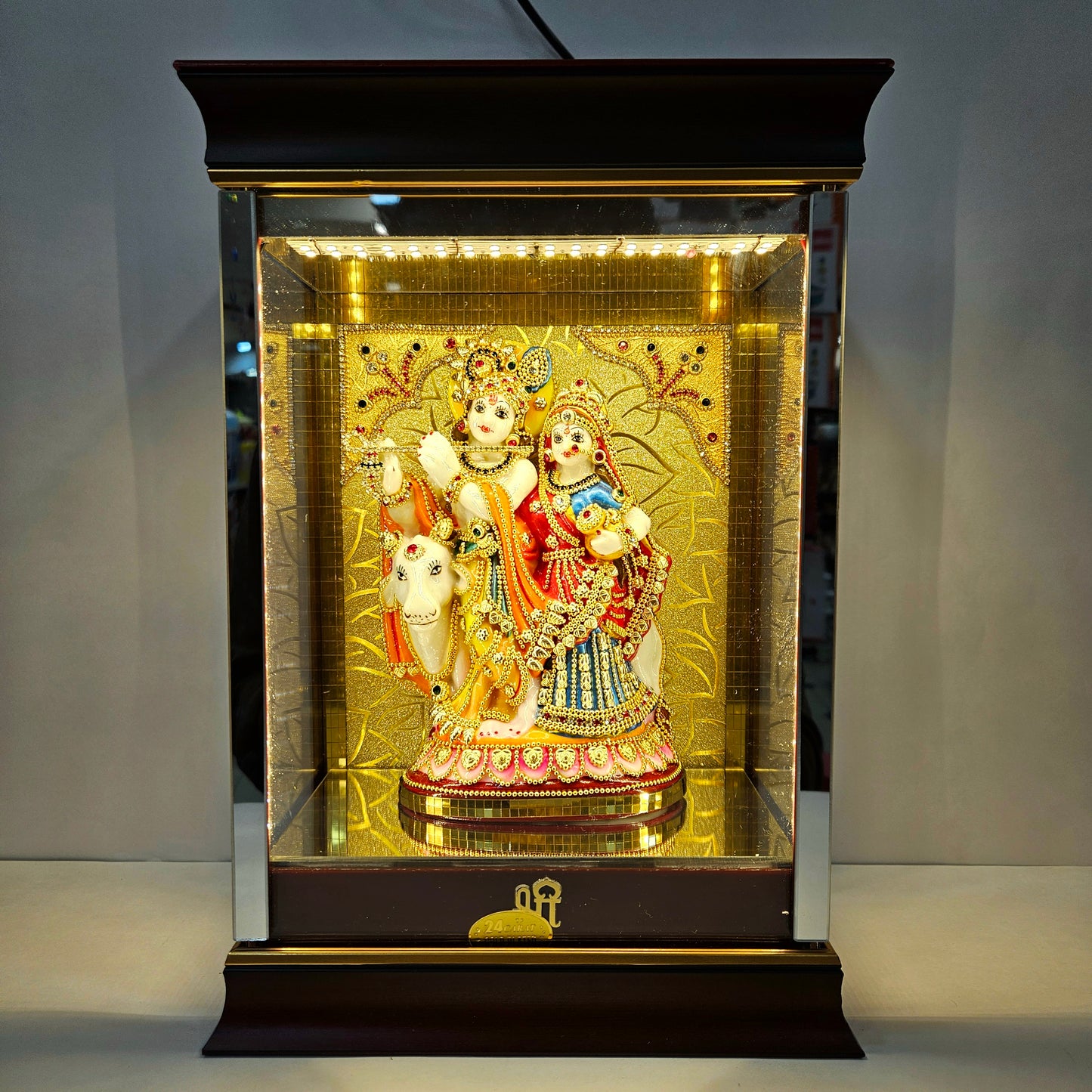 Radha Krishna attractive stones designed 24 carats gold Plated idol Statue showpiece in a transparent protective cabin