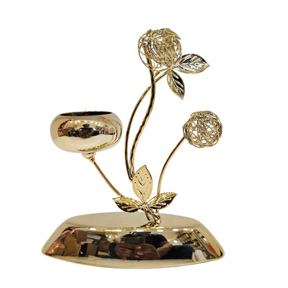Golden metal tealight candle holder polished finish, intricate branch designs, and a single cup for holding candle