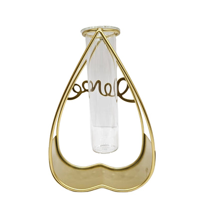 Gold heart-shaped metal frame stand features a clear glass tube for propagation