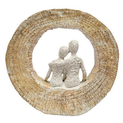 Textured, sand-finish couple figurine seated inside a circular arch, often sold as modern resin home décor