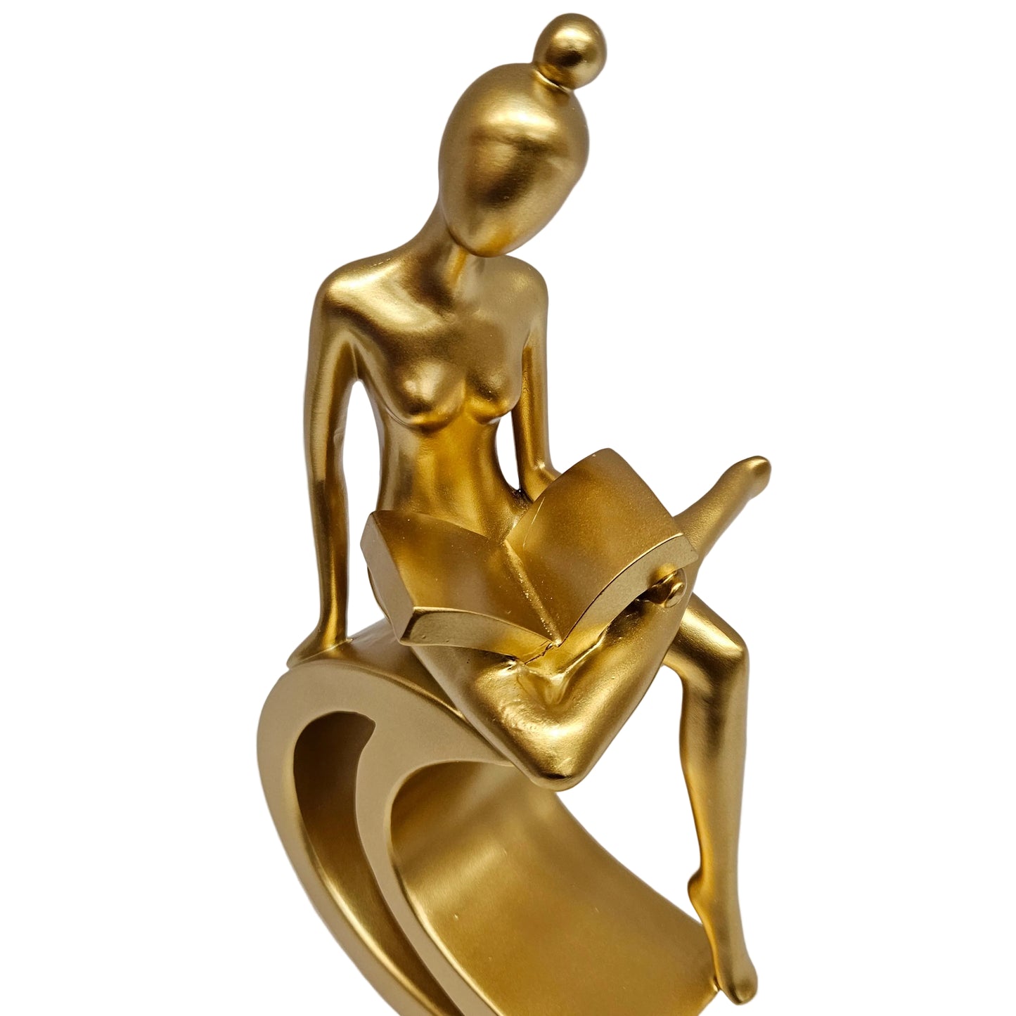 Gold-finished resin statue depicts a stylized figure reading a book while perched upon a crescent moon.