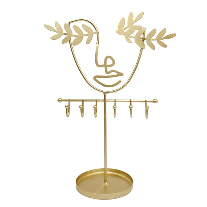 Abstract wire face jewelry stand designed to organize and display accessories like necklaces, rings, and earrings