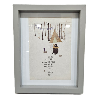 Decorative wall art print in a gray frame featuring a whimsical bear character photo frame