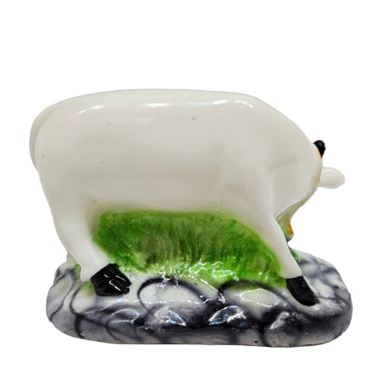 Decorative ceramic Kamadhenu Cow with Calf statue, commonly used in Hindu worship rooms or for home decor