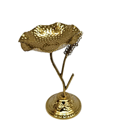 Golden metal urli stand is designed for decorative purposes, often used for holding floating flowers or tealight candles