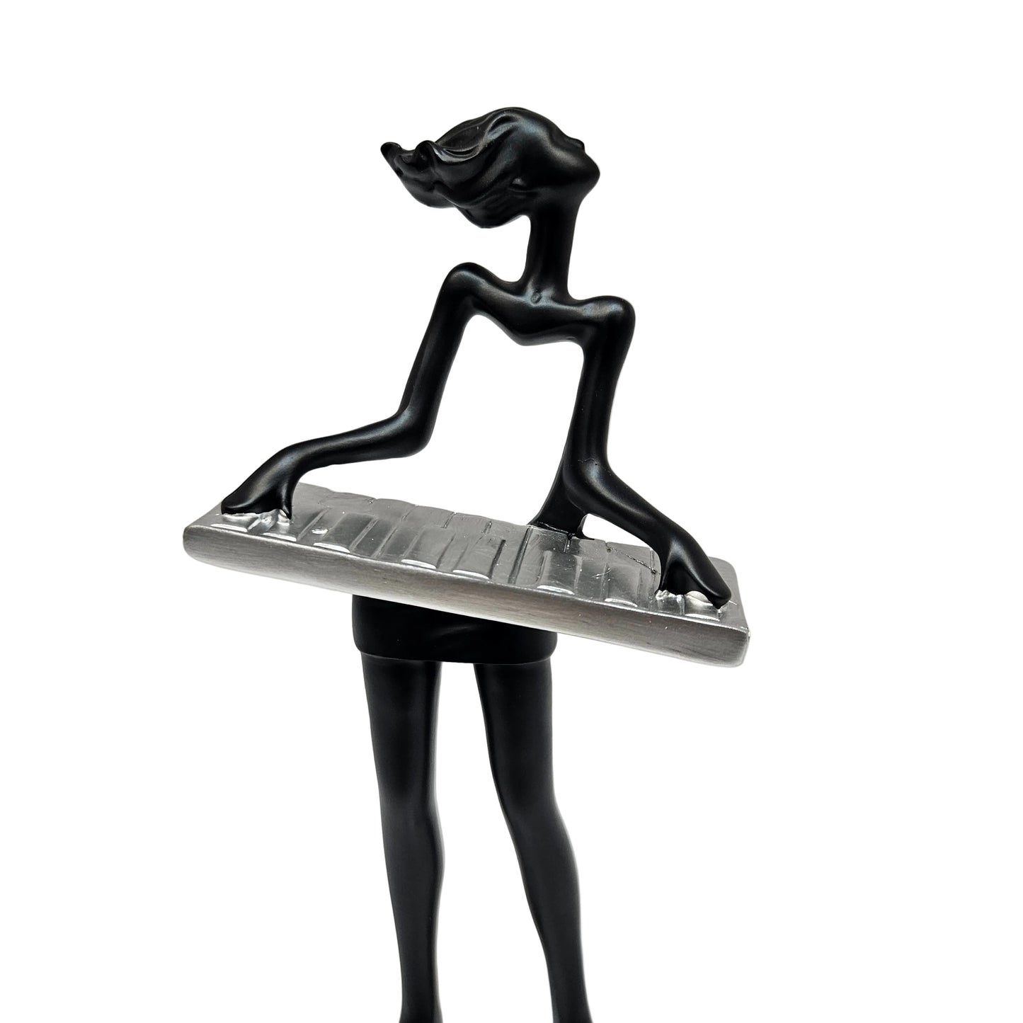 Sleek black modern art lady sculpture of a musician playing a silver keyboard