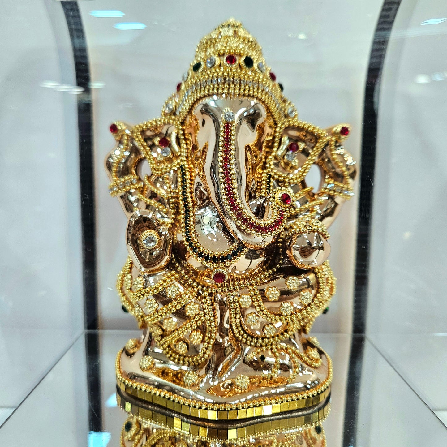 Lord vinayaka 24 carats gold Plated idol Decorated with attractive stones in a transparent protective cabin