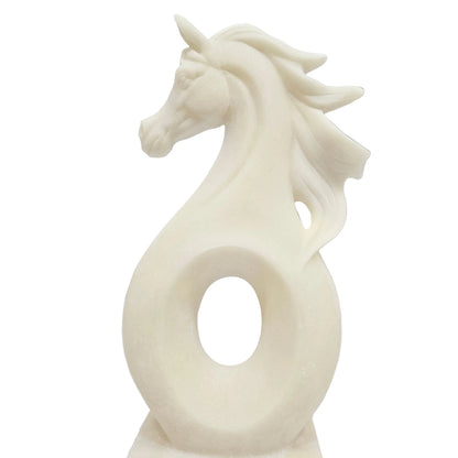 This white polyresin horse sculpture is designed with a minimalist, abstract aesthetic featuring a flowing mane and a circular opening in the center